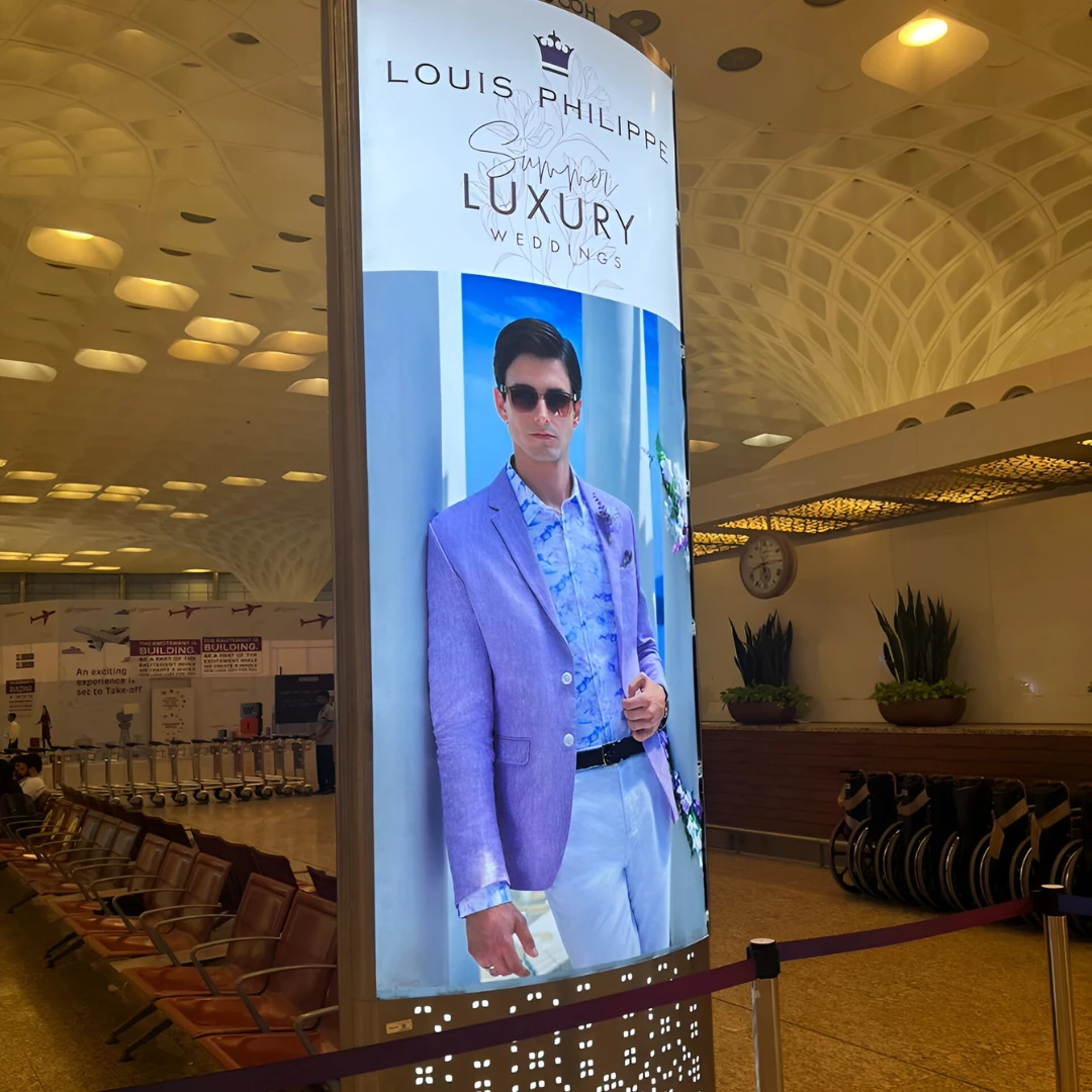 Louis Philippe Summer Luxury Weddings campaign featuring Luca Bold in a lilac suit, on a full-height airport pillar in India
